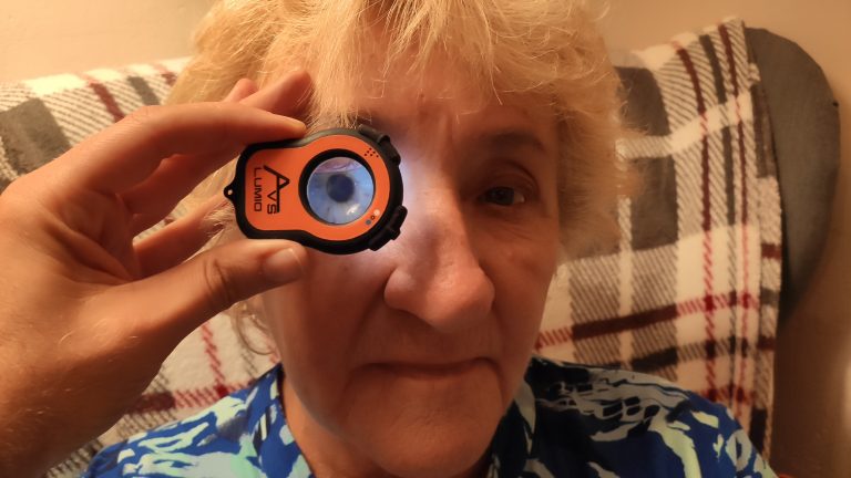 Patient being examined in their home using the Lumio anterior eye examination tool to test vision