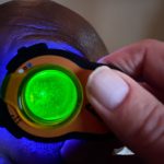 Man undergoing advanced eye examination with the Lumio device and clip-in fluorescein wratten filter by Aston Vision Sciences