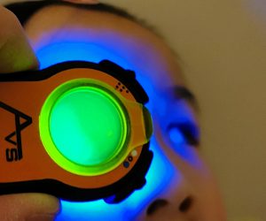 Child undergoing a fluorescein-enhanced eye exam with the Lumio device by Aston Vision Sciences