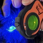 Dog undergoing an eye exam with the Lumio device after fluorescein dye application, highlighting corneal details under blue light