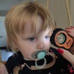 Young child being examined using the AVS Lumio device during home visit
