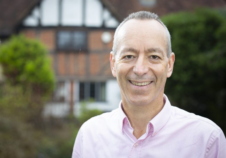 Paul smiling with a blurred background