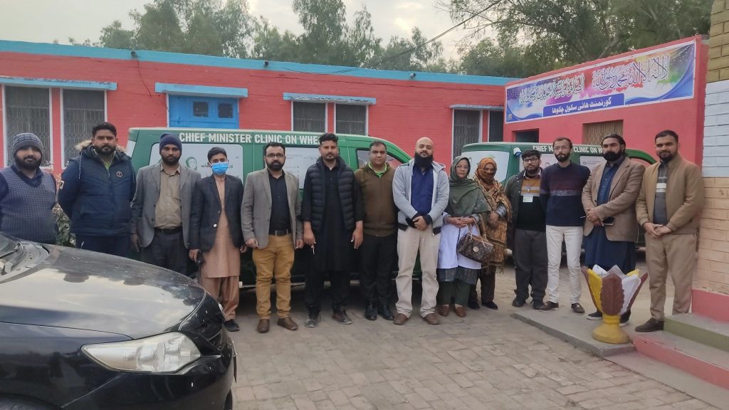 Several eye clinicians standing in front of a community centre