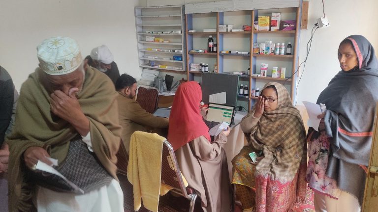 Patient sitting and standing waiting for eye tests